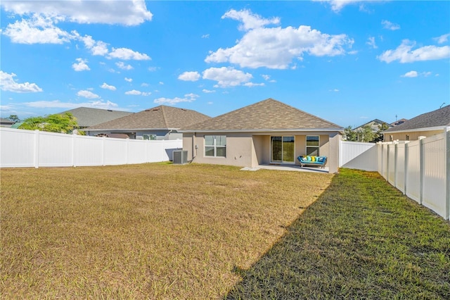 rear view of house with a yard, central AC unit, and a patio