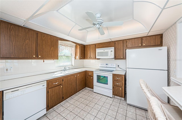 kitchen with light tile patterned floors, white appliances, ceiling fan, and sink