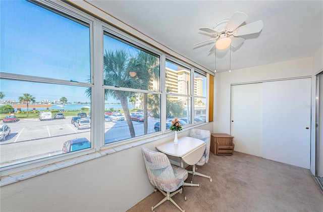 sunroom featuring ceiling fan