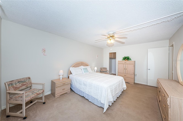 carpeted bedroom with a textured ceiling and ceiling fan