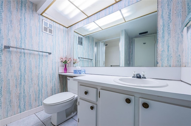 bathroom with tile patterned flooring, vanity, and toilet