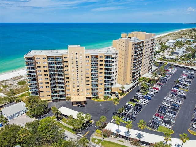 drone / aerial view with a water view and a view of the beach