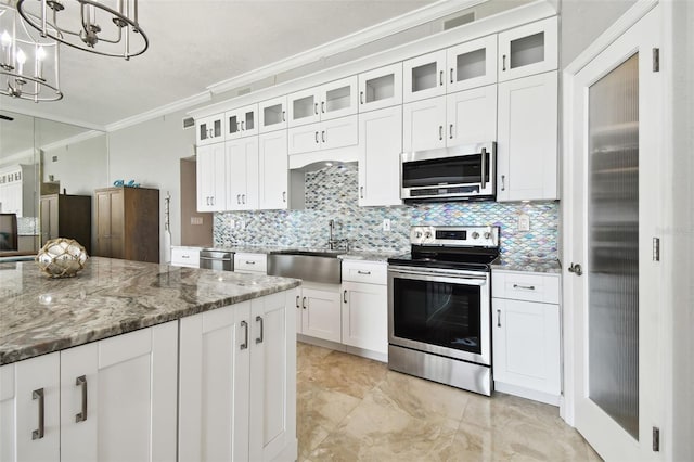 kitchen featuring backsplash, sink, hanging light fixtures, white cabinetry, and stainless steel appliances