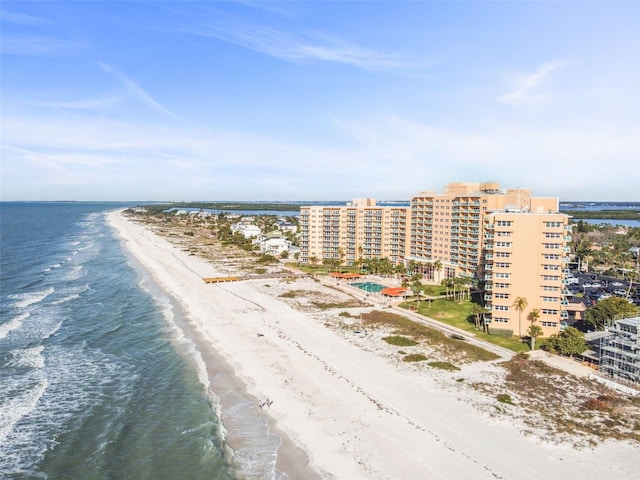 drone / aerial view featuring a water view and a beach view