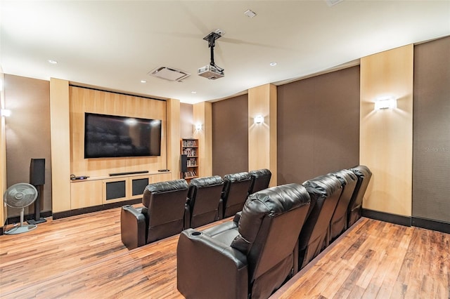 cinema room with light hardwood / wood-style flooring