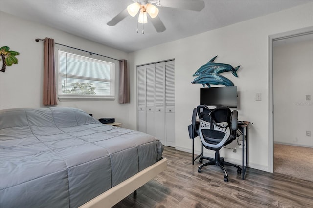 bedroom featuring ceiling fan, a closet, and hardwood / wood-style floors