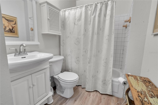full bathroom with vanity, hardwood / wood-style flooring, toilet, and shower / bathtub combination with curtain