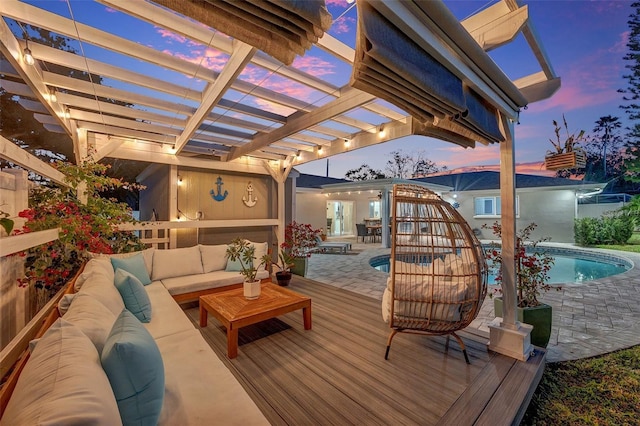 patio terrace at dusk featuring outdoor lounge area, a swimming pool side deck, and a pergola