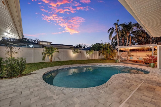 pool at dusk with a patio