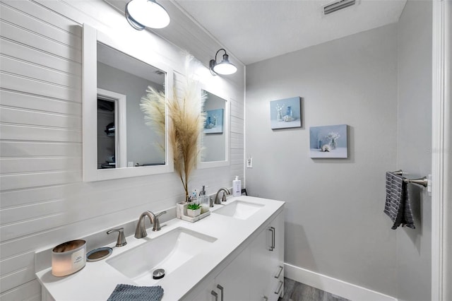 bathroom with vanity, wood-type flooring, and a textured ceiling