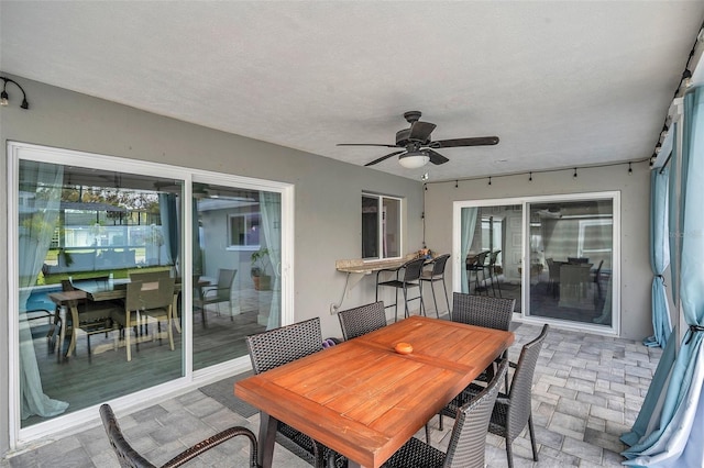 sunroom with ceiling fan and a healthy amount of sunlight