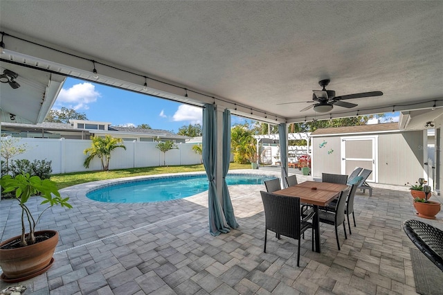 view of pool featuring a patio area and a storage unit