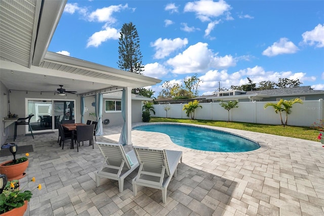 view of swimming pool featuring ceiling fan and a patio