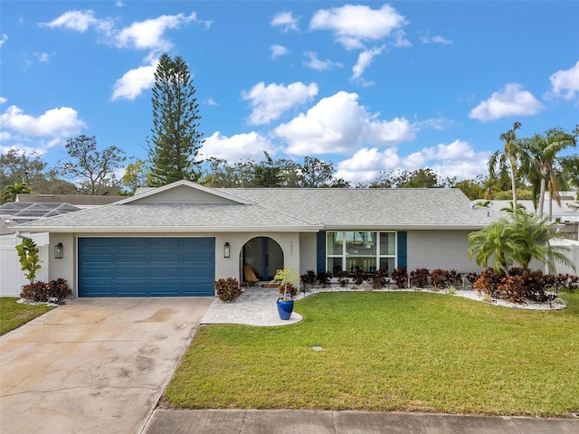 ranch-style home with a front yard and a garage