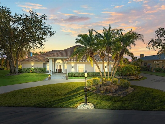 mediterranean / spanish-style house featuring a lawn