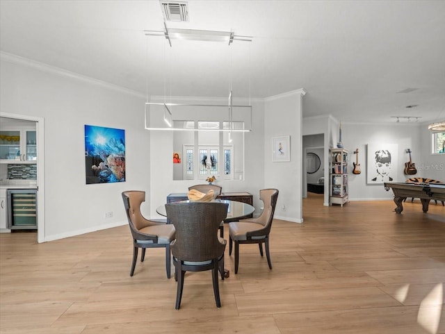 dining room featuring light hardwood / wood-style floors, wine cooler, ornamental molding, and billiards