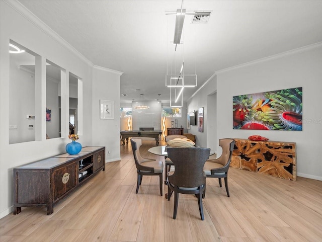 dining area with light hardwood / wood-style flooring and ornamental molding