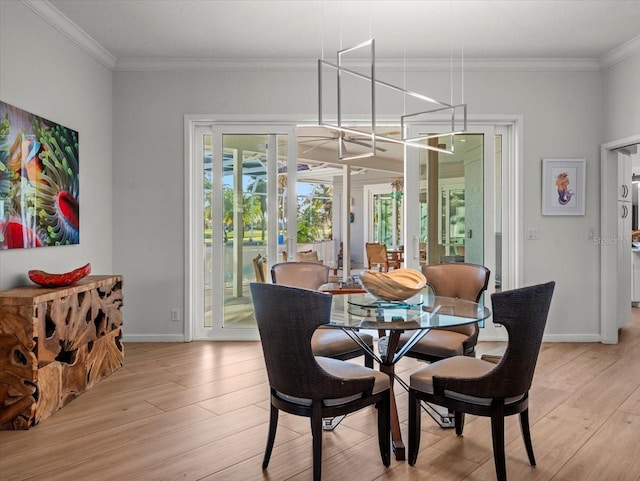 dining room with light hardwood / wood-style floors, ornamental molding, and french doors