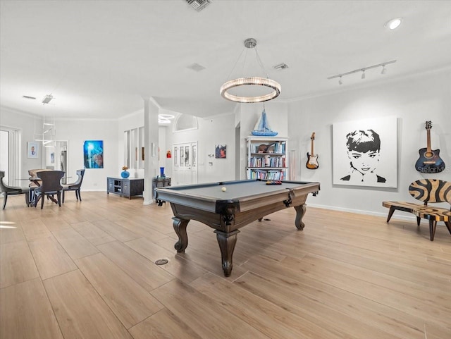 game room with light hardwood / wood-style flooring, ornamental molding, and pool table