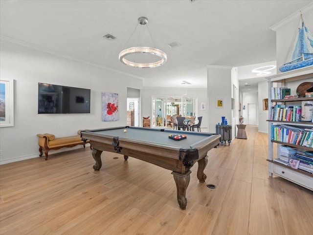 rec room with light hardwood / wood-style floors, crown molding, pool table, and an inviting chandelier