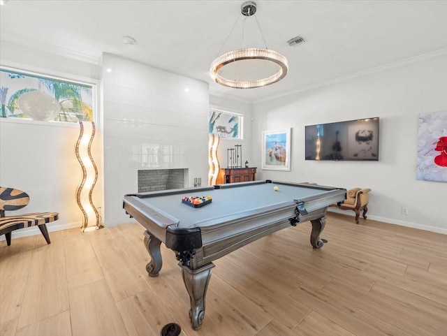 rec room with light hardwood / wood-style floors, crown molding, and billiards