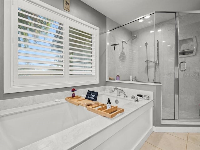 bathroom featuring tile patterned flooring, plenty of natural light, and independent shower and bath