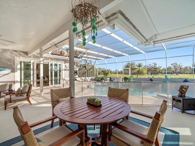 sunroom / solarium featuring a pool and lofted ceiling