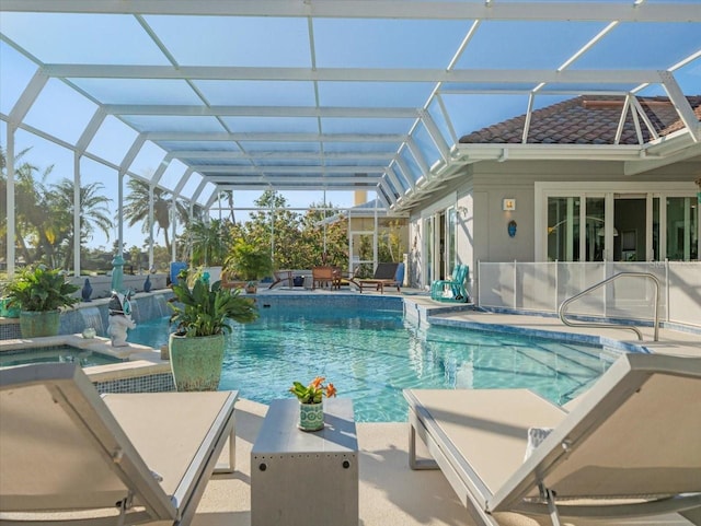 view of pool with an in ground hot tub, a patio, and glass enclosure