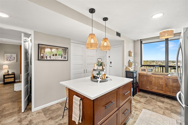 kitchen featuring pendant lighting, a center island, and stainless steel refrigerator