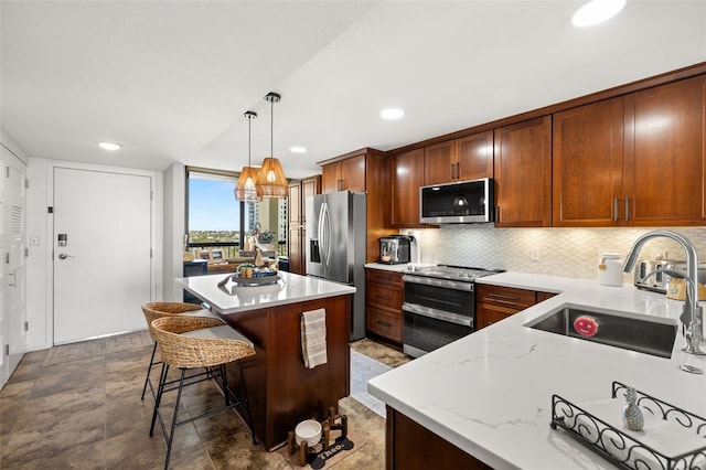 kitchen with sink, a center island, tasteful backsplash, pendant lighting, and appliances with stainless steel finishes