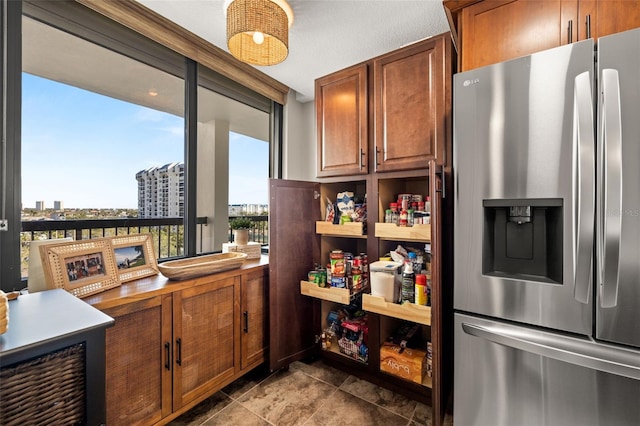 kitchen featuring stainless steel refrigerator with ice dispenser