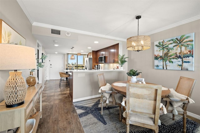 dining space with dark hardwood / wood-style floors, crown molding, and a notable chandelier