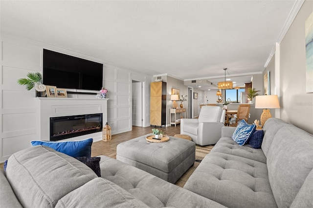 living room featuring light hardwood / wood-style flooring and ornamental molding