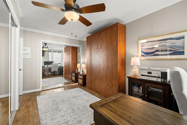 home office with ornamental molding, a textured ceiling, and hardwood / wood-style flooring