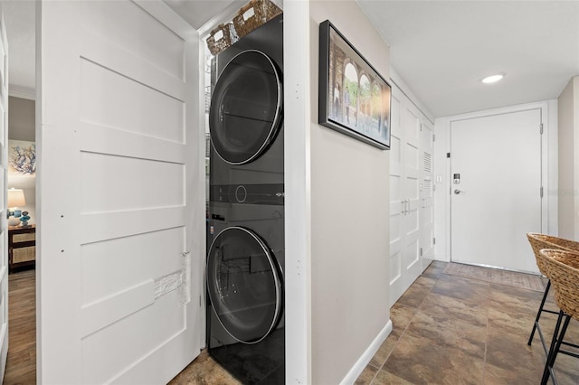 laundry area with stacked washer and clothes dryer