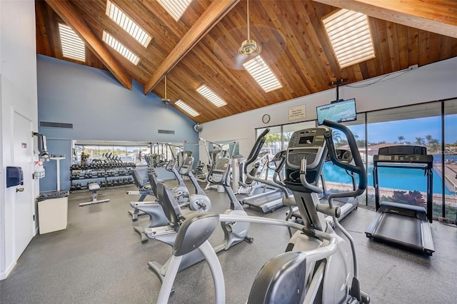 exercise room with high vaulted ceiling and wooden ceiling