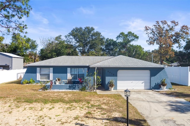 single story home with a garage and a front lawn