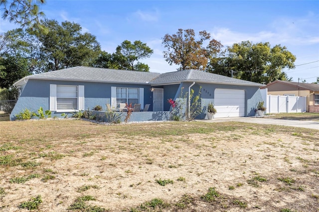 ranch-style home featuring a garage