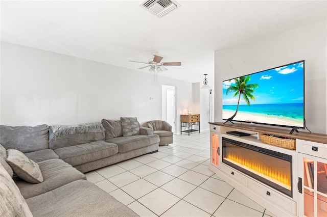 living room with ceiling fan and light tile patterned flooring