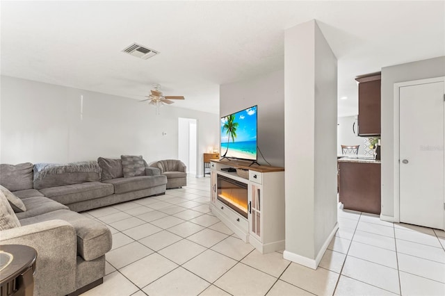 living room featuring ceiling fan and light tile patterned floors