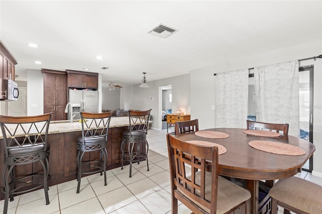 tiled dining area featuring ceiling fan