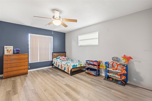 bedroom featuring light hardwood / wood-style floors and ceiling fan