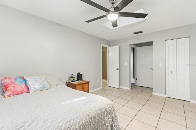 tiled bedroom featuring ceiling fan