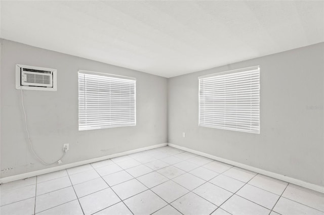 tiled empty room with a wall mounted AC