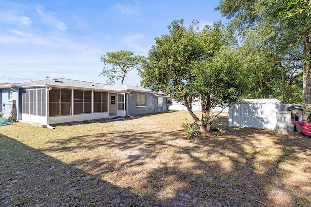 back of house with a sunroom and a yard