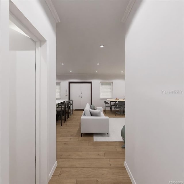 hall featuring light hardwood / wood-style floors and ornamental molding