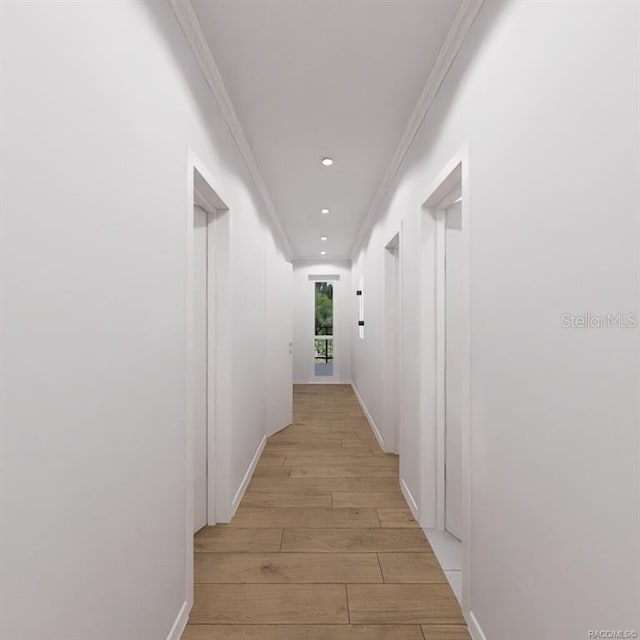 corridor featuring light wood-type flooring and crown molding