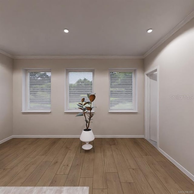 empty room with crown molding and light hardwood / wood-style floors