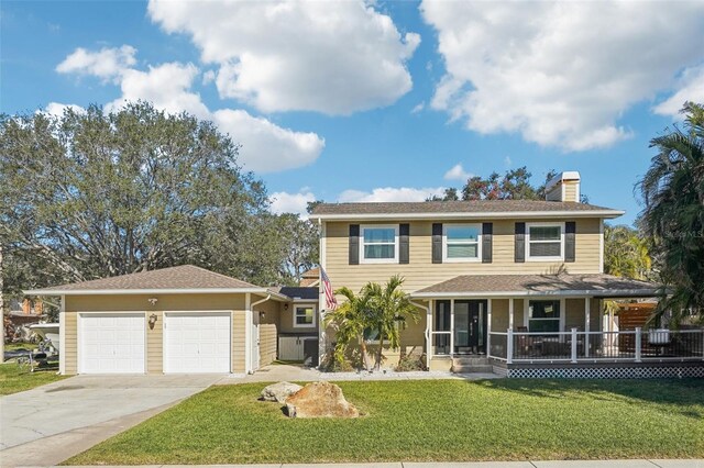 13945 75th Ave, Seminole, FL 33776 - view of front facade featuring a chimney, driveway, an attached garage, a front lawn, and a porch