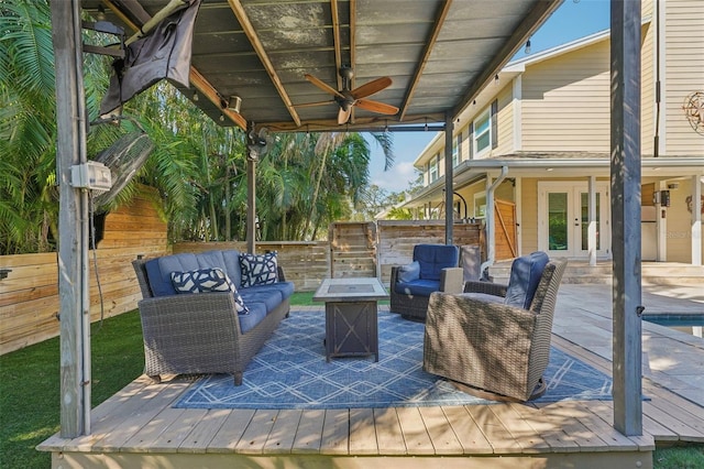 13945 75th Ave, Seminole, FL 33776 - deck featuring french doors, an outdoor living space with a fire pit, fence, and ceiling fan